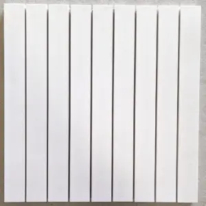 White wall-mounted radiator with multiple vertical panels in a row