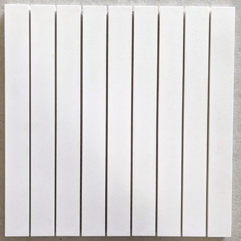 White wall-mounted radiator with multiple vertical panels in a row