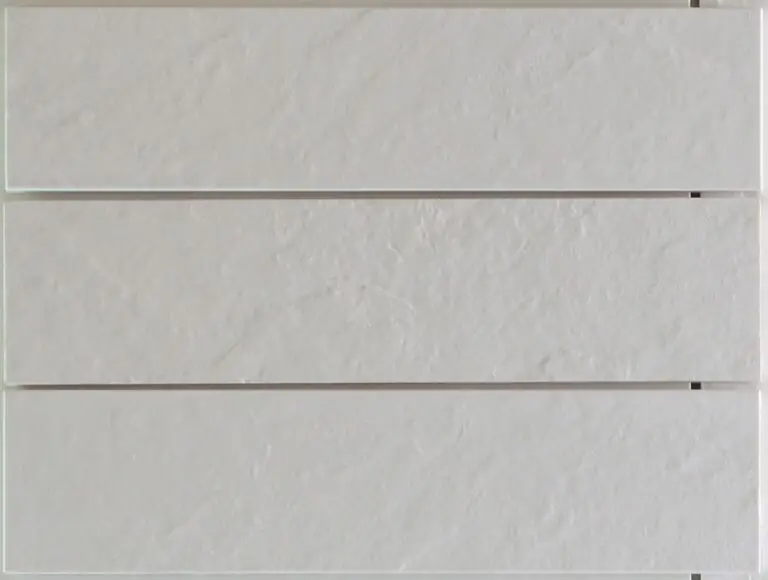 Close-up of three white textured horizontal wall panels with small gaps at the right edge.
