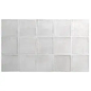 Light gray square tiles arranged in a neat grid on a wall, with visible grout lines.