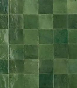 Close-up of glossy green ceramic tiles in a grid pattern with varying shades of green and subtle grout lines