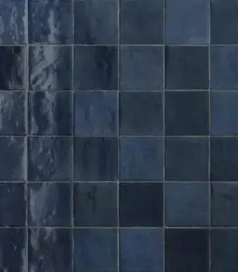 Close-up of dark blue glossy ceramic tiles in a grid pattern.