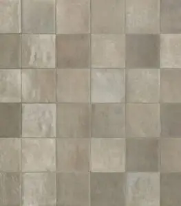 Beige and gray square tiles in a uniform grid pattern, resembling a stone tile surface.