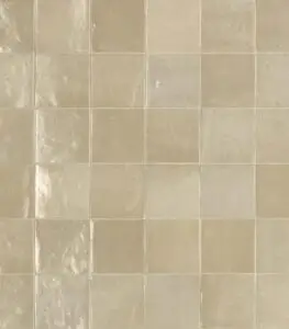 Beige square ceramic tiles with light grout lines forming a grid pattern.