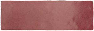 Rectangular red brick with rough, uneven surface texture.