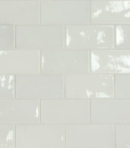 Glossy white subway tile wall with horizontal rows and light grout lines.