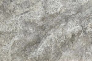 Close-up of a rough gray concrete texture with mottled, weathered patterns.