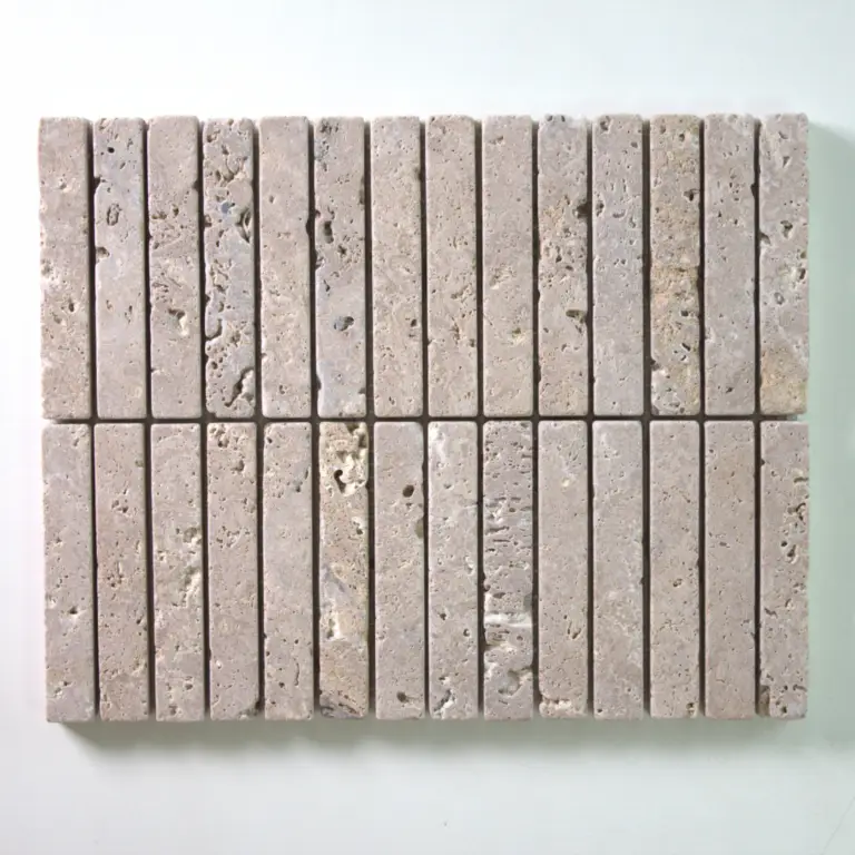 Row of light gray porous concrete bricks arranged in a neat horizontal row on a white surface.