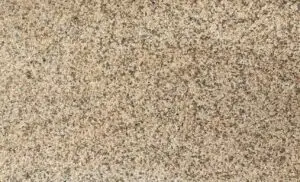 Close-up of a speckled granite surface with pink, black, and gray grains.