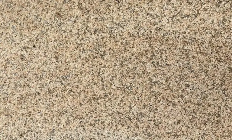 Close-up of a speckled granite surface with pink, black, and gray grains.