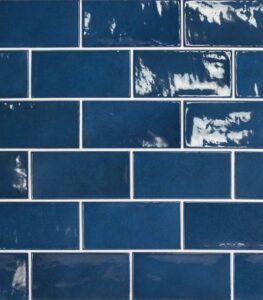Blue glazed brick wall with white grout lines.