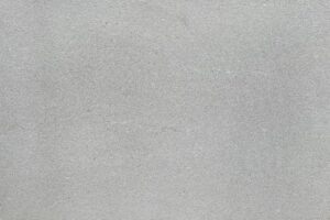 Close-up of a light gray concrete surface with a subtle, speckled texture