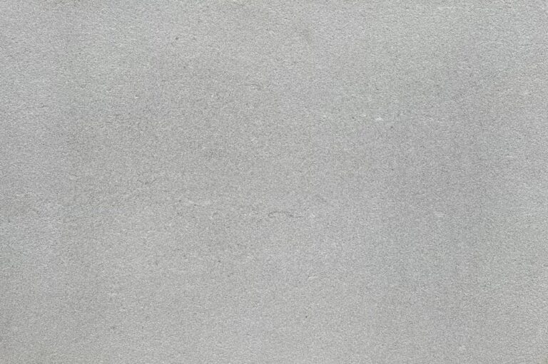 Close-up of a light gray concrete surface with a subtle, speckled texture