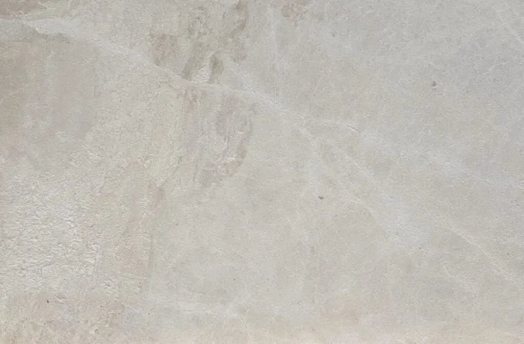 Light gray concrete wall with a rough, textured surface and subtle markings.