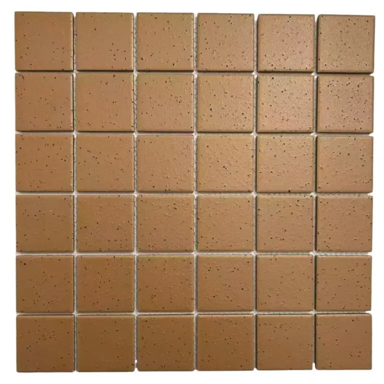 Brown square ceramic tiles arranged in a uniform 6-by-7 grid, showing speckled texture and light grout lines.