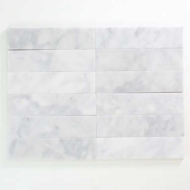 Rectangular white marble tiles arranged in a neat grid on a white surface.