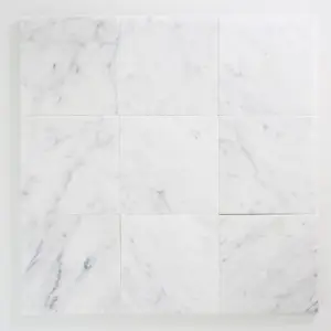 Nine white marble tiles with light gray veining arranged in a 3x3 grid.