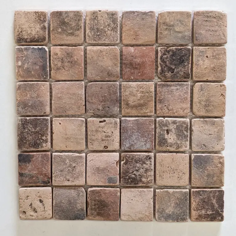 Six-by-six grid of small square stone tiles in earthy beige and brown tones, weathered texture with rough edges.