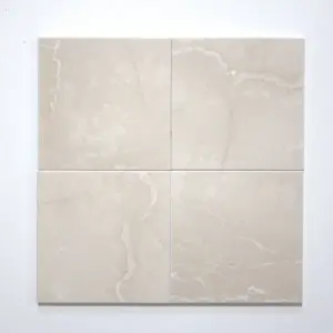 Four beige marble tile panels arranged in a 2x2 grid on a white wall, showing subtle veining and grout lines.