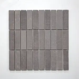 Grey rectangular tile samples arranged in a grid on a light surface, showing subtle texture and color variation across pieces.