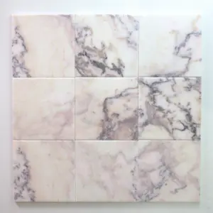 Nine square marble tiles arranged in a 3x3 grid, featuring pale pink and white with gray veining across the surfaces.