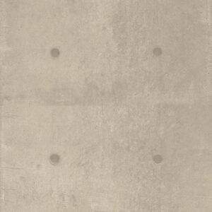 Beige concrete wall featuring four evenly spaced circular holes arranged in a square pattern.