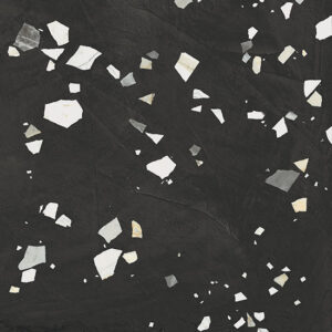 Dark textured background with irregular white and light gray chip fragments scattered across.